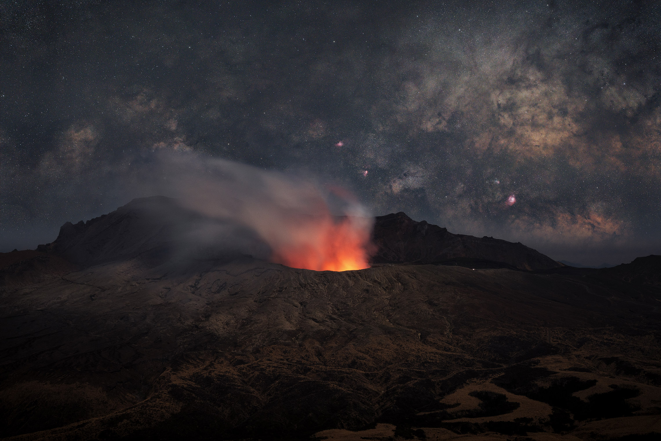 a volcano appears in the foreground with stars and the sky in the background