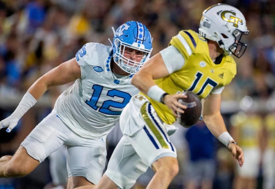 North Carolina's Beau Atkinson presses Georgia Tech quarterback Haynes King (10) in the first quarter on Saturday, October 28, 2023 at Bobby Dodd Stadium in Atlanta, Georgia.