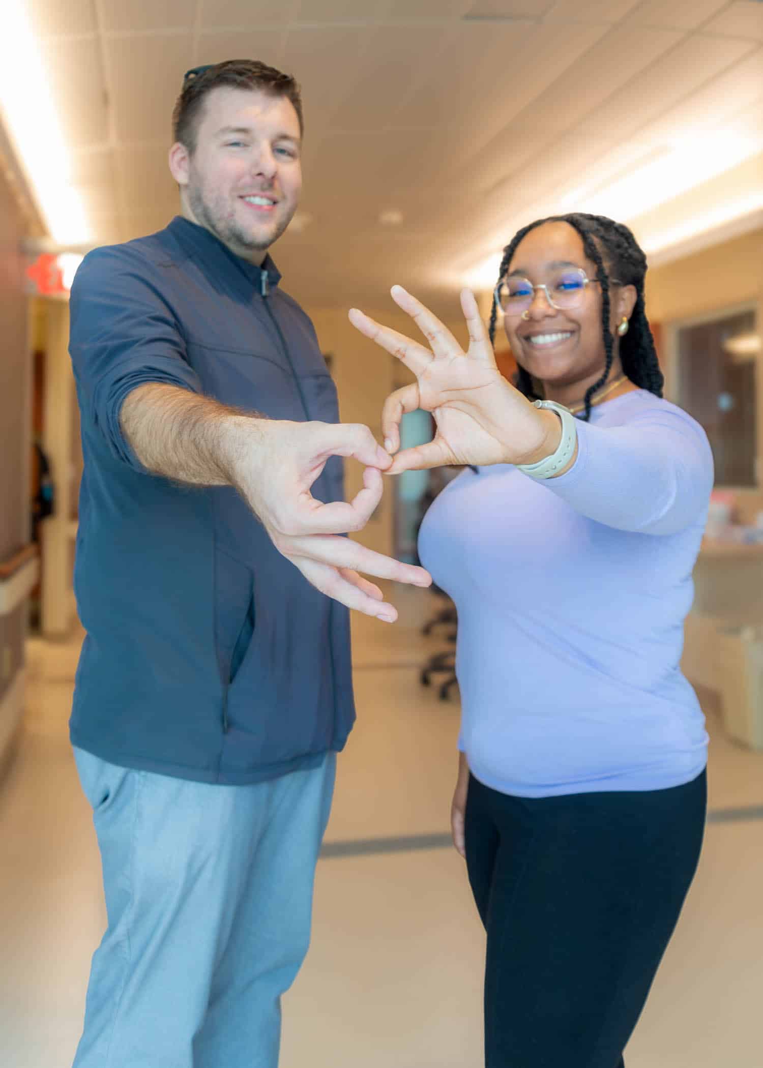 Two ECU Health interpreters interpret hands in American Sign Language.