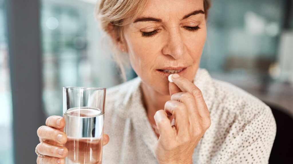 A woman taking aspirin