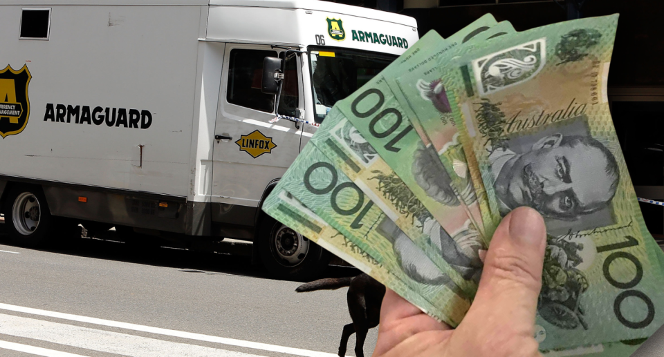 An Armaguard truck is next to someone holding a large $100 bill