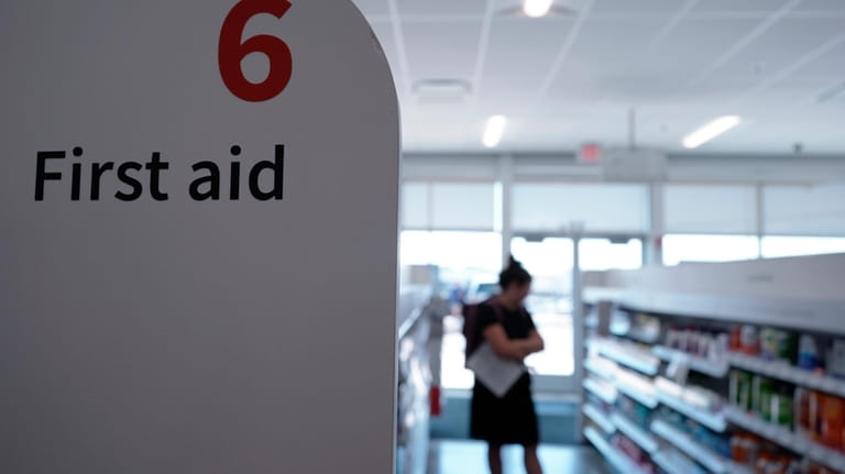 A customer looks at the Walgreens first aid aisle...