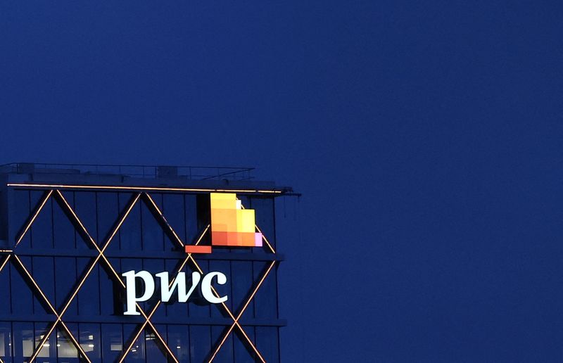 The logo of accounting firm PricewaterhouseCoopers (PwC) is seen on the top of a Brussels