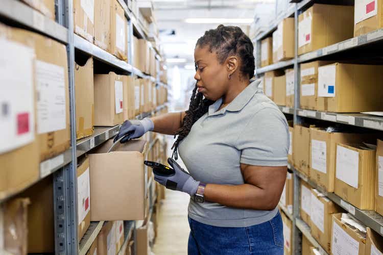 A female African-American employee working in an executive office