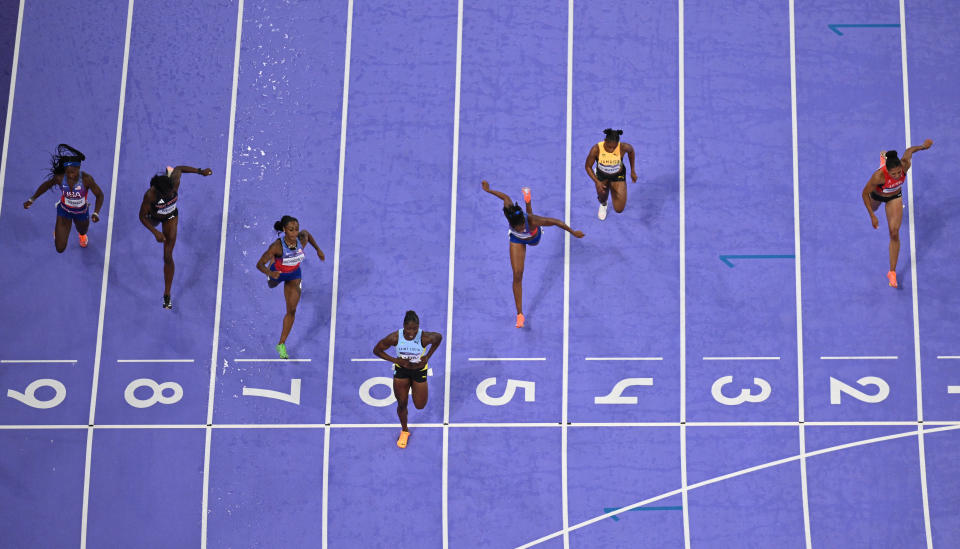 St Lucia's Julien Alfred crosses the line, followed by America's Sha'Carri Richardson and Melissa Jefferson in the women's 100m final of the athletics event at the Paris 2024 Olympic Games at the Stade de France in Saint-Denis, north in Paris, in August.  3, 2024. (Photo by Jewel SAMAD/AFP) (Photo by JEWEL SAMAD/AFP via Getty Images)